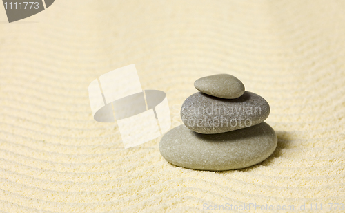 Image of Pyramid of three stones on sand