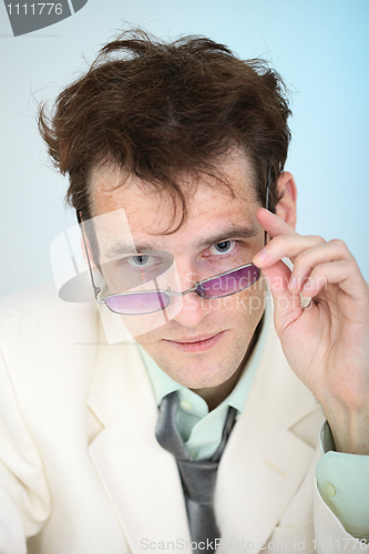 Image of Funny disheveled young smiling man with spectacles