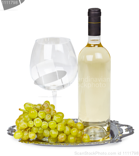 Image of Bottle of white wine, glass and grapes on metal tray