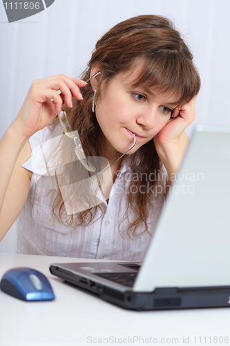 Image of Young beautiful woman with concentration studies laptop
