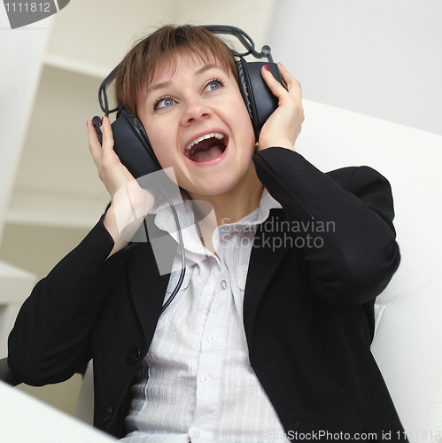 Image of Cheerful woman with a big stereo headphones