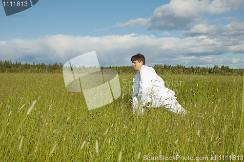 Image of Man does exercises in field