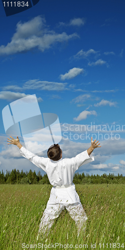 Image of Person has lifted hands to blue sky - happiness