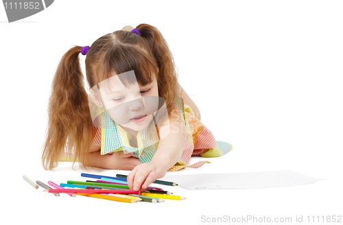 Image of Child draws with color pencils on white