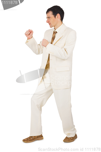 Image of Young businessman in combat stance