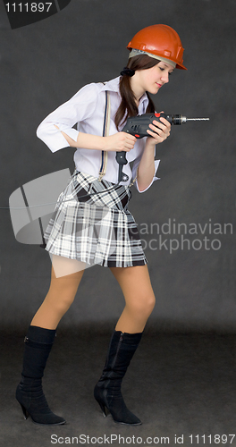 Image of Female student learns to use power tools