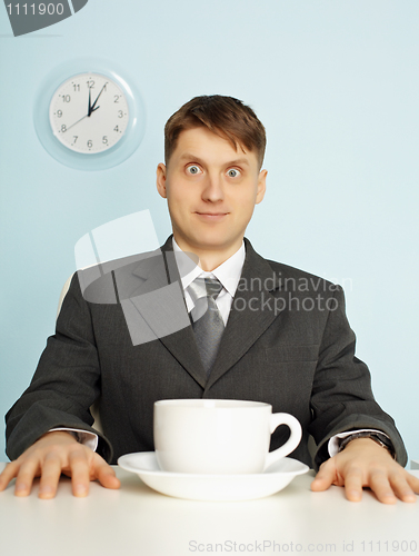 Image of Businessman has drunk coffee and stare wide-eyes