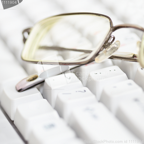 Image of Spectacles lie on keyboard