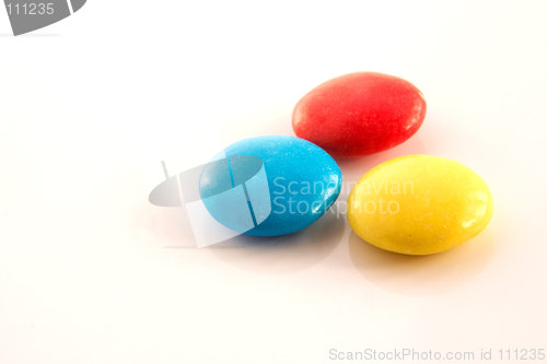 Image of three colored candy buttons