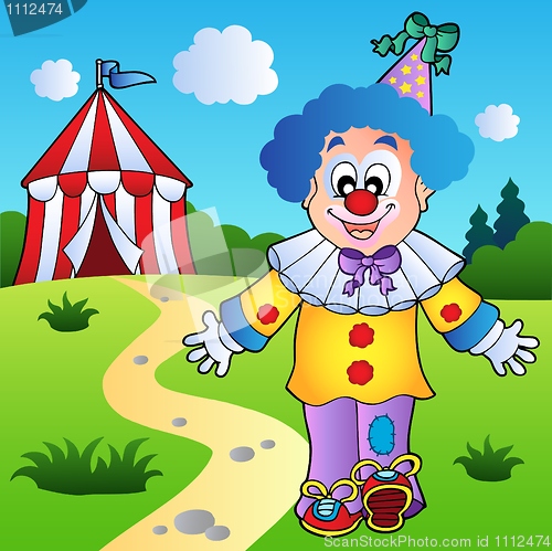 Image of Smiling clown with circus tent