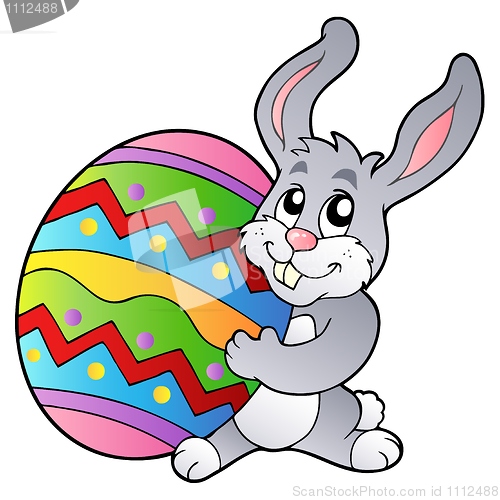 Image of Cartoon bunny holding Easter egg