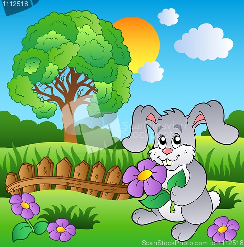 Image of Meadow with bunny holding flower