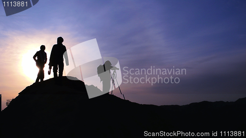 Image of Silhouette of photographers at sunrise