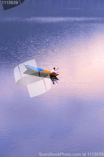 Image of Scenery of a lake with a fishing boat