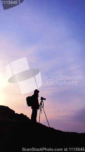Image of Silhouette of a photographer at sunrise