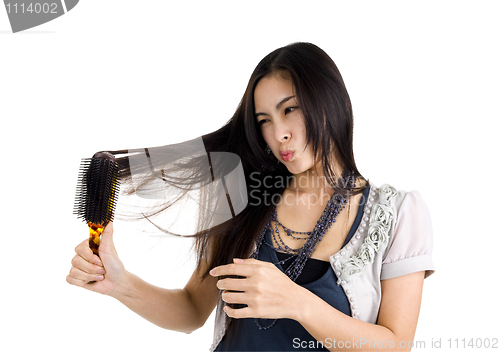 Image of woman brushing her hair