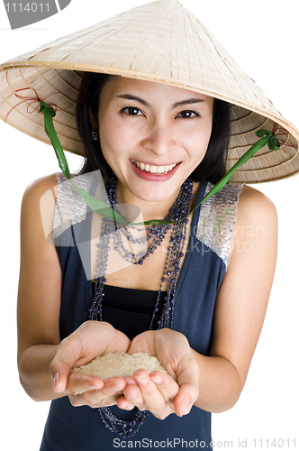 Image of  woman with rice in her hands