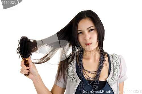 Image of woman brushing her hair