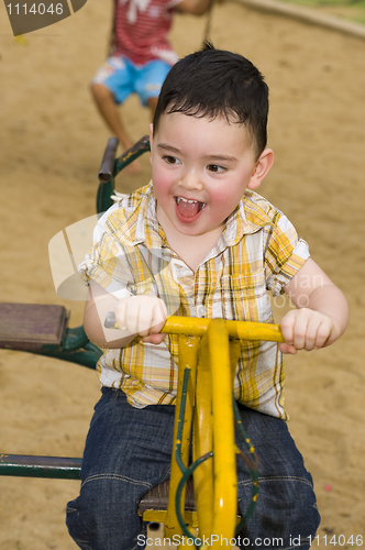 Image of cute boy on a carousel