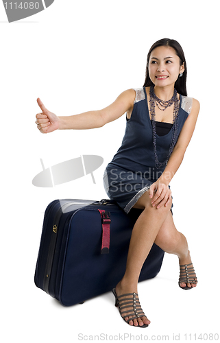 Image of pretty woman hitchhiking