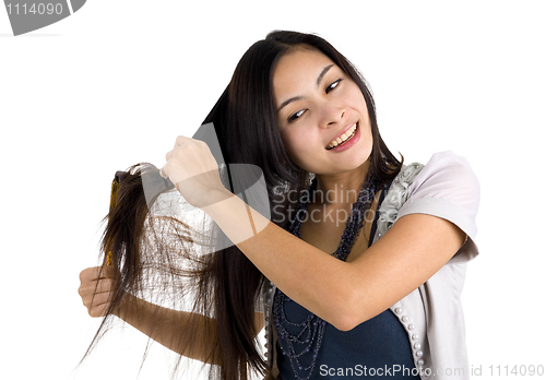 Image of woman brushing her hair