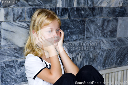 Image of blond girl with bad mood