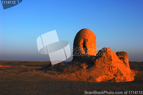 Image of Relics of an ancient castle in the desert at sunrise