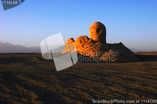 Image of Relics of an ancient castle in the desert at sunrise