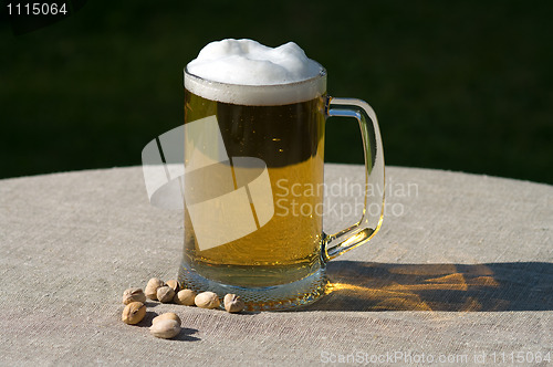 Image of Mug of beer and nuts.