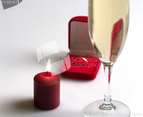 Image of Still life with a candle and champagne.