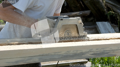 Image of The person works as a power saw