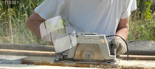 Image of The man with a circular saw