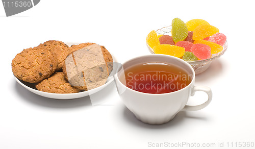 Image of Tea, cookies and fruit candy.