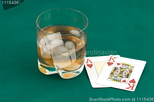 Image of Cards and a glass of whisky.