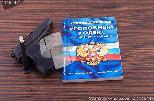 Image of Pistol and book.