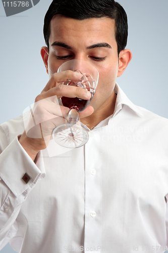 Image of Man tasting drinking wine