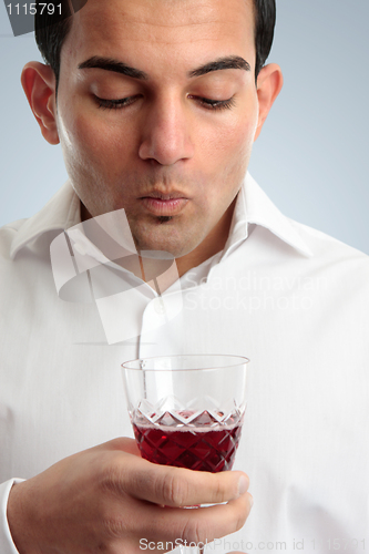Image of Man tasting red wine