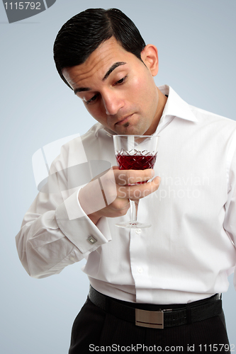 Image of Man inspecting wine