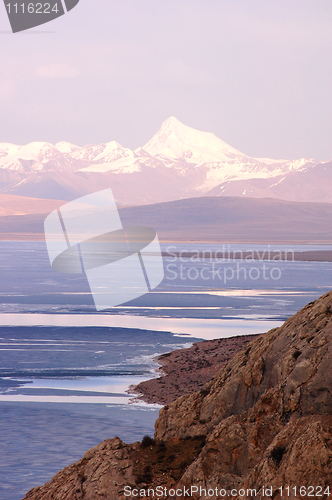 Image of Blue lake and snow mountains at sunrise