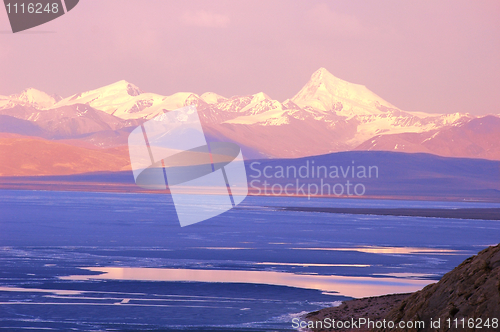 Image of Blue lake and snow mountains at sunrise