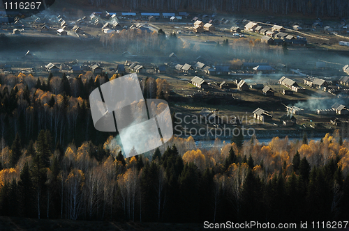 Image of Landscape of a small village with woods in an autumn morning