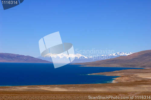 Image of Landscape of blue lake and snow covered mountains