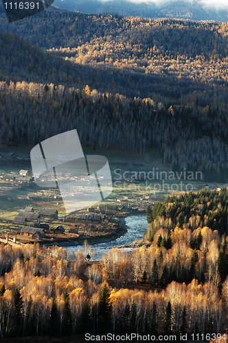 Image of Landscape of a small village with woods in an autumn morning