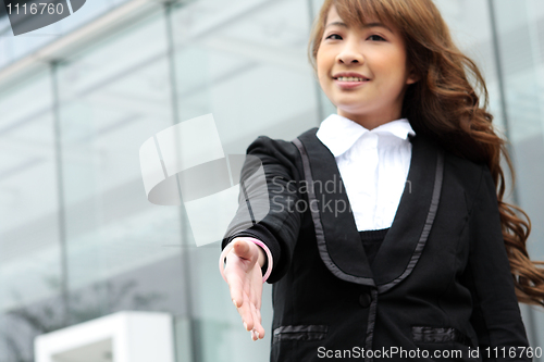 Image of Portrait of a woman with an open hand ready to seal a deal 