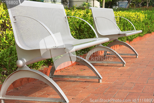 Image of two steel chair in the park