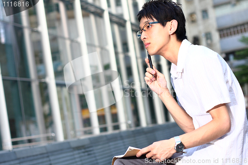 Image of young man studying at outdoor