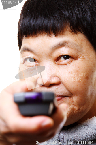 Image of Portrait of a senior woman watching TV