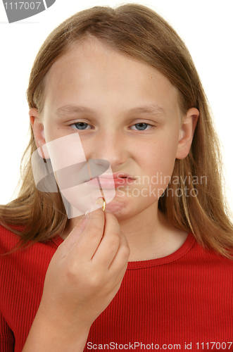 Image of young girl taking a pill