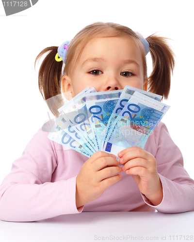 Image of Little girl with few paper euro banknotes