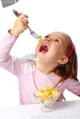 Image of Little girl eats fruit salad